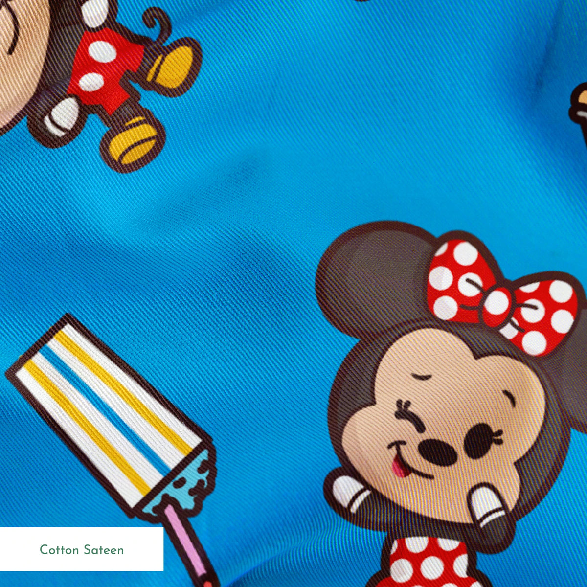 Mickey, friends, and food items pattern on blue background, featuring Mickey, Minnie, Donald, and fruit icons springs sateen texture