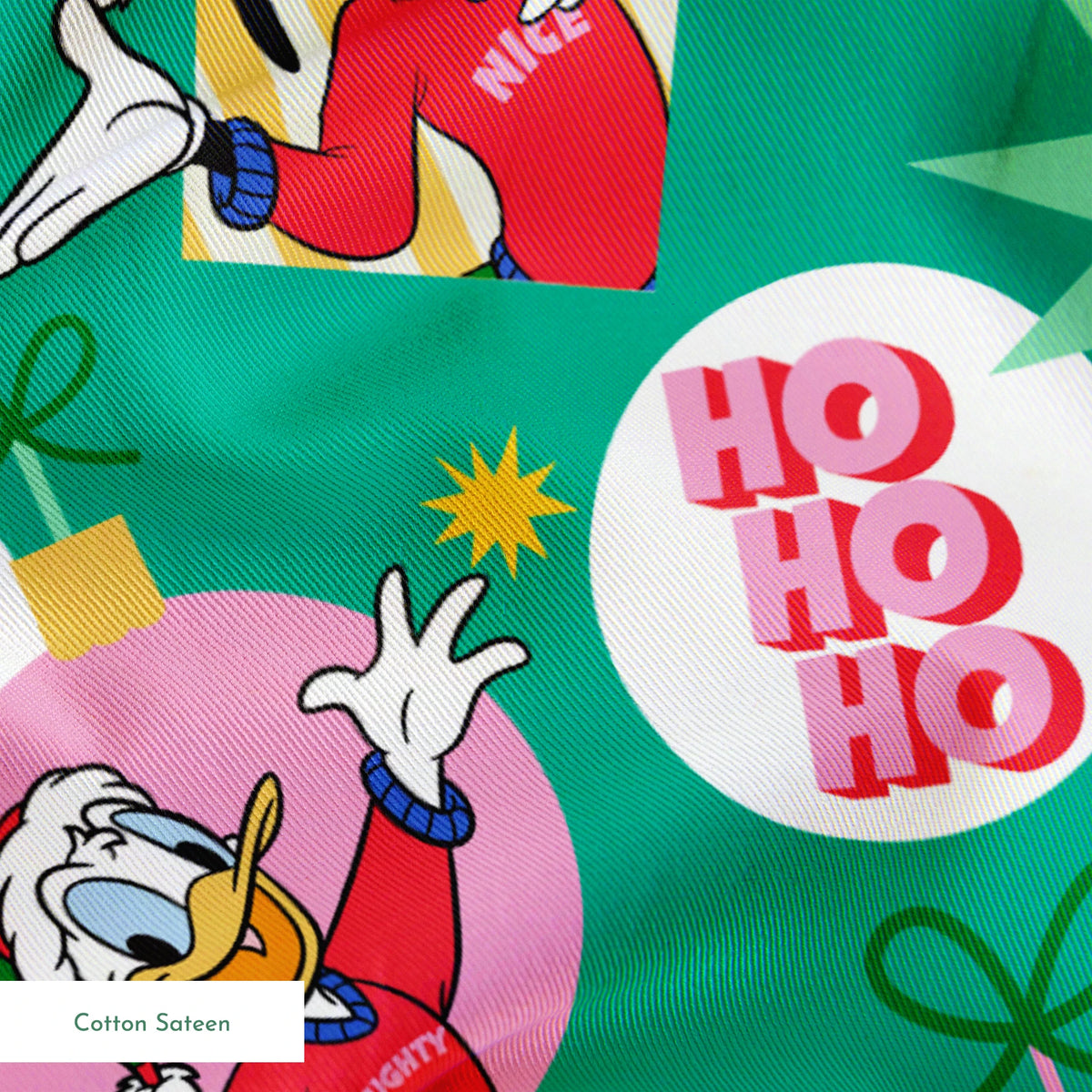 Festive Disney characters on green holiday pattern with "Ho Ho Ho" text and Christmas ornaments springs sateen texture