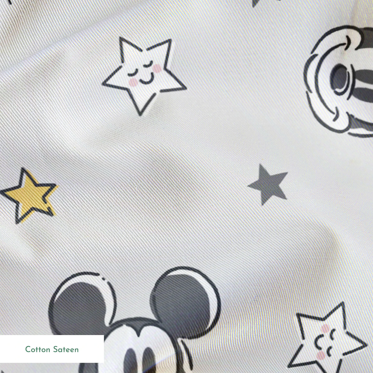 Mickey and Minnie Mouse pattern with stars on light gray background springs sateen texture