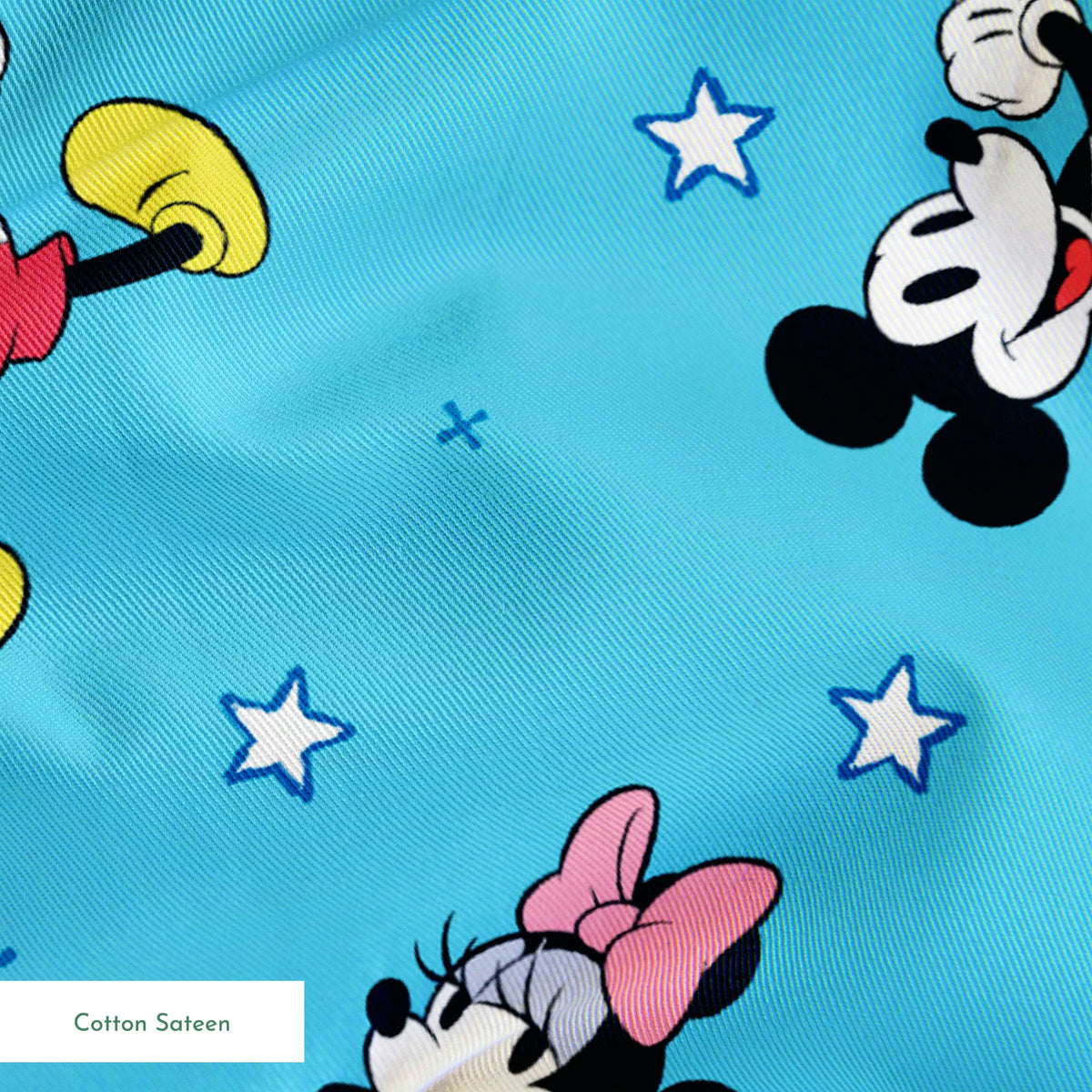 Disney Mickey Mouse and Minnie Mouse characters on light blue background with white stars, pattern design springs sateen texture