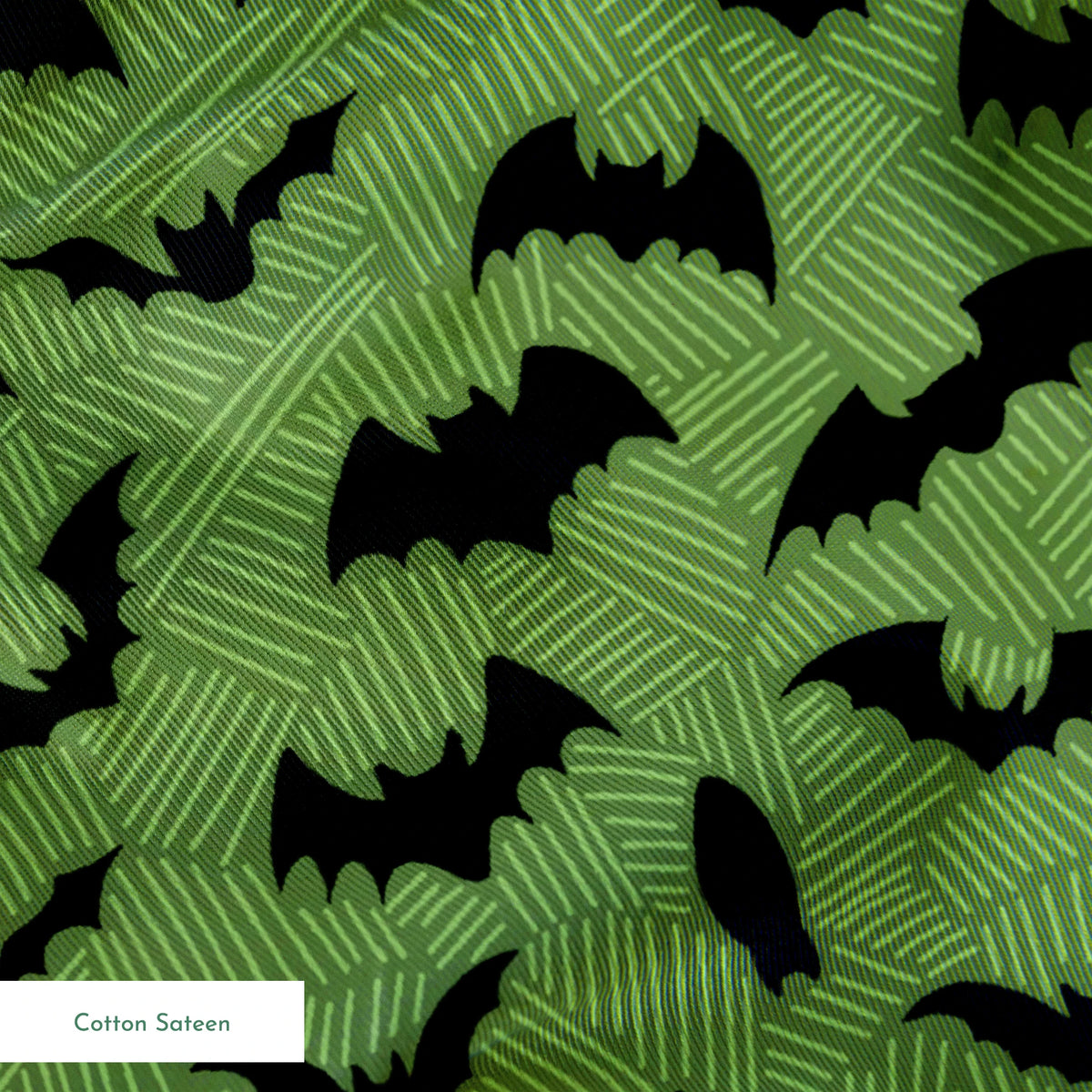Black bat silhouettes scattered across a green textured background with zigzag pattern springs sateen texture