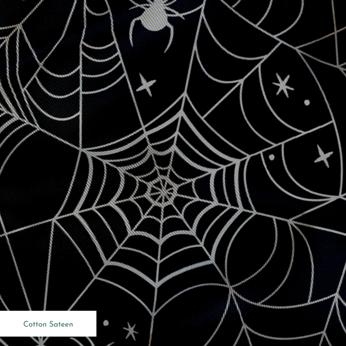 Spooky Halloween pattern with white spiderwebs, orange Mickey Mouse heads, and gray spiders on black background springs sateen texture