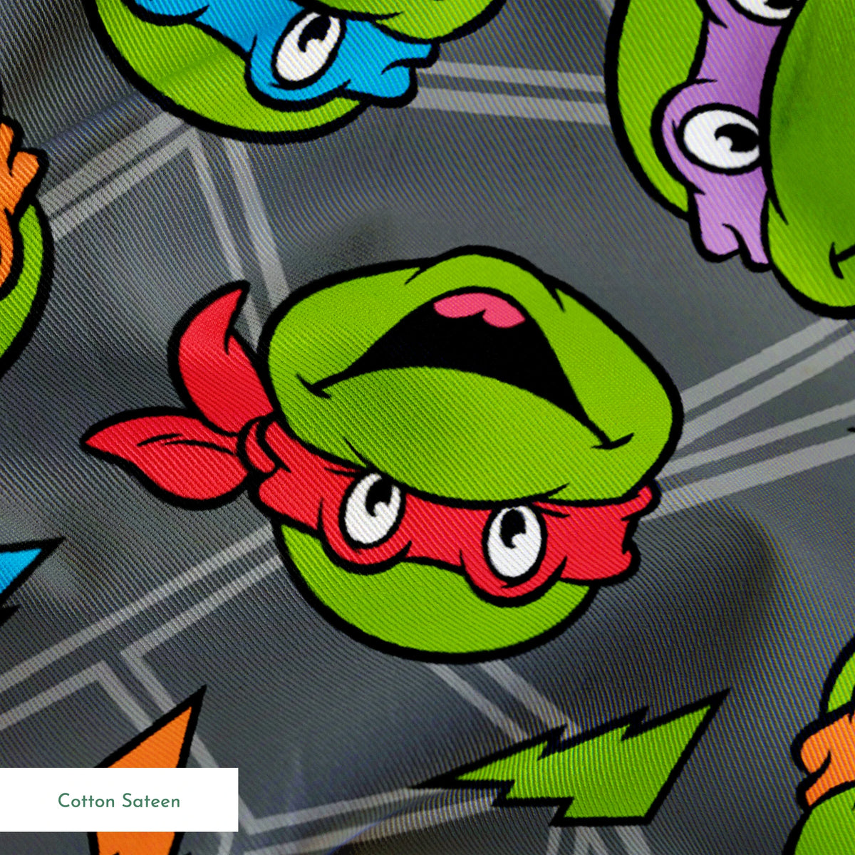 Colorful pattern of Teenage Mutant Ninja Turtles faces with red, orange, blue, and purple masks on grey background. springs sateen texture