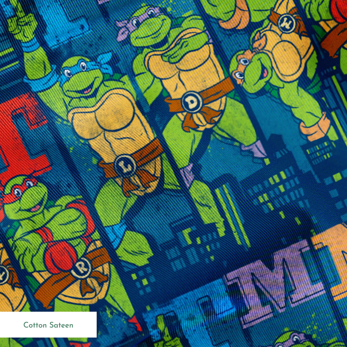 Colorful Teenage Mutant Ninja Turtles cartoon pattern with characters and "TMNT" text on blue cityscape background springs sateen texture