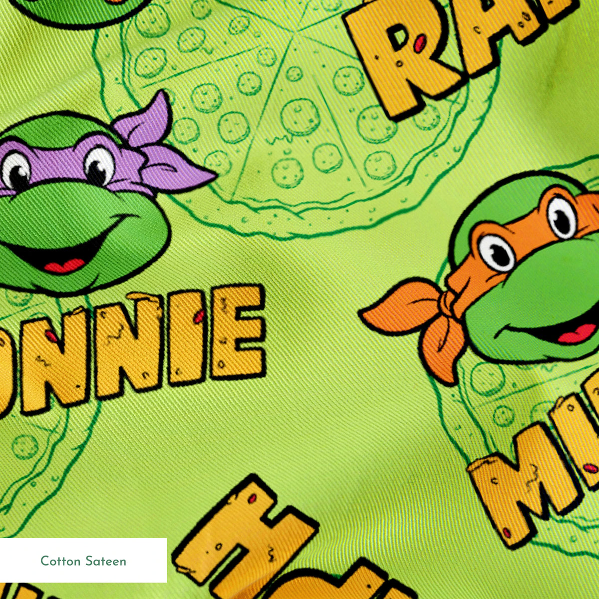Teenage Mutant Ninja Turtles pattern with cartoon faces, names, and colorful masks on green background springs sateen texture