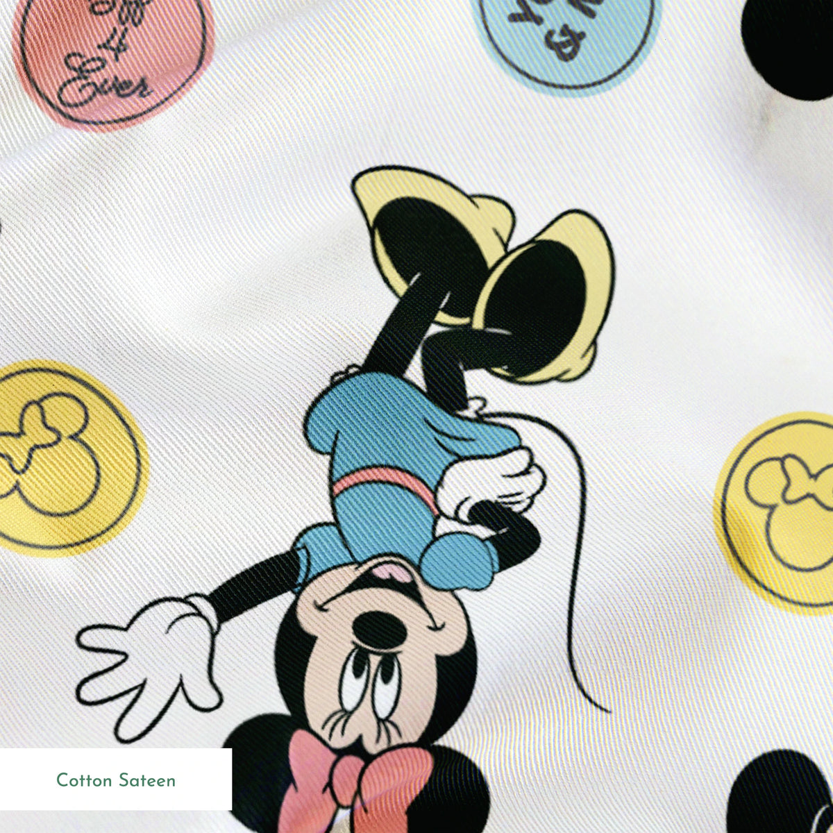 Mickey Mouse and Minnie Mouse cartoon pattern with colorful circles containing phrases on white background. springs sateen texture