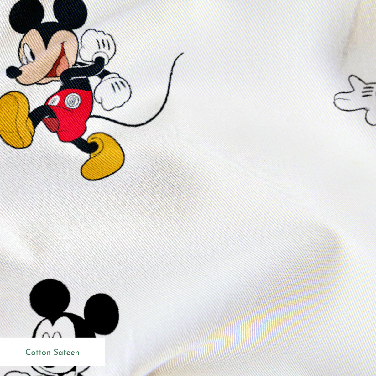 Repeating pattern of Mickey Mouse cartoon characters in various poses on white background springs sateen texture