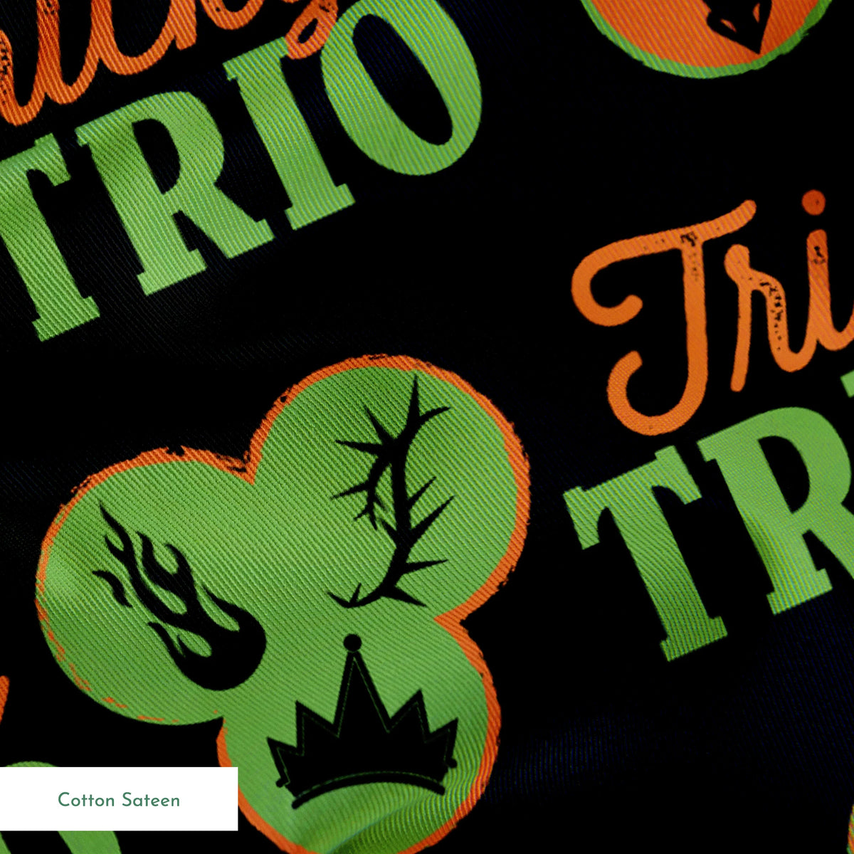 Disney Halloween pattern with "Tricky TRIO" text in orange and green, featuring Disney Villains, pumpkins, and ghostly designs on black background springs sateen texture