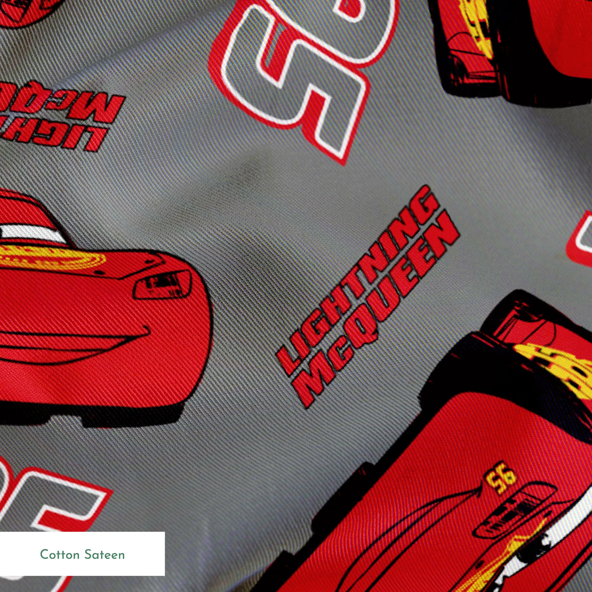 Lightning McQueen pattern with red race cars and number 95 on gray background springs sateen texture