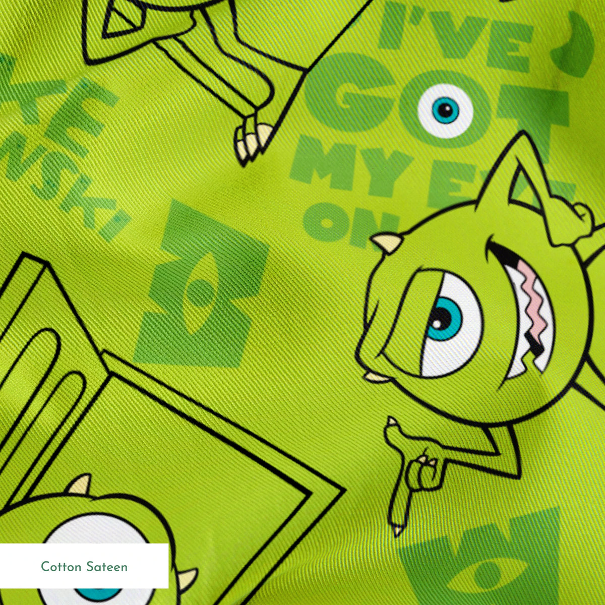 Green background with repeating Mike Wazowski in black outlines. springs sateen texture