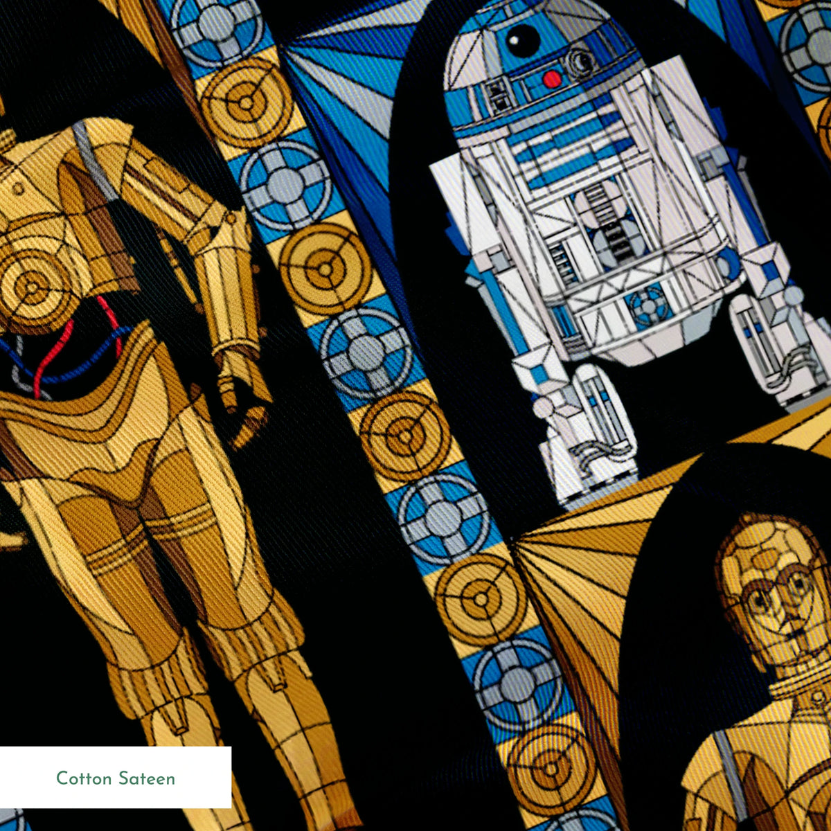 Repeating pattern of golden droid and blue-white astromech droid characters from Star Wars on black background with decorative borders springs sateen texture