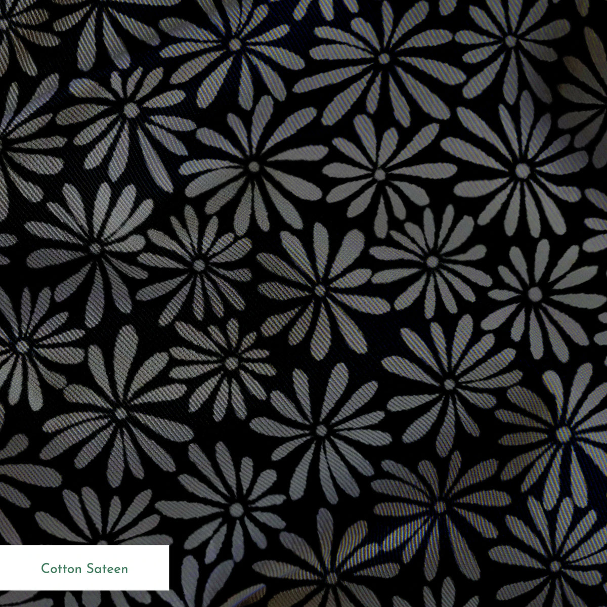 Tonal gray daisy ditsy floral fabric on a black background, designed by Nicole Tamarin – ideal for modern quilting and neutral sewing projects. springs sateen texture