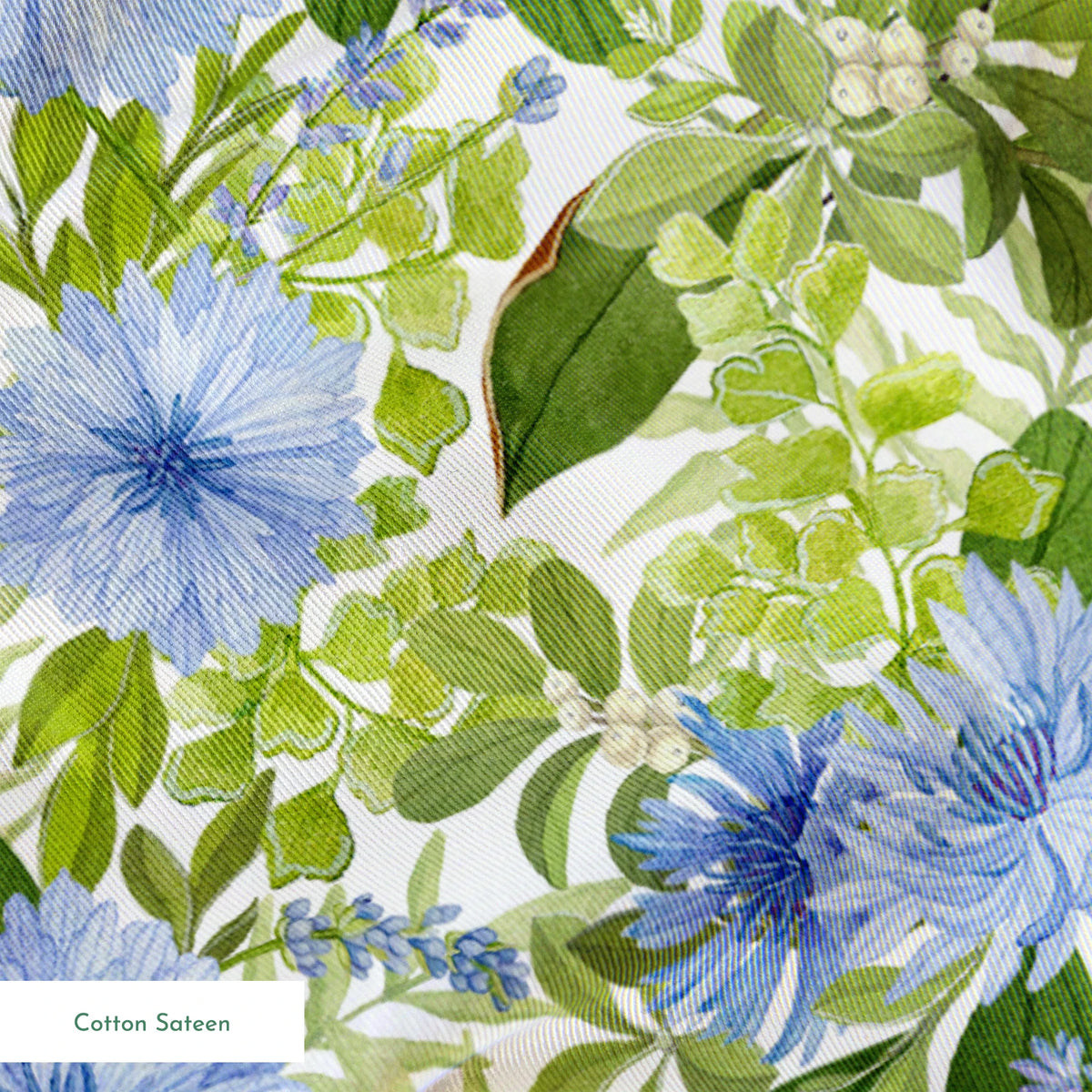 Watercolor-style botanical fabric pattern featuring blue wildflowers and soft green foliage on a white background. Designed by Nicole Tamarin. springs sateen texture