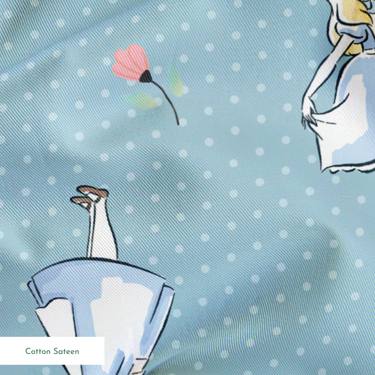 Blue polka dot pattern with illustrated characters in blue dresses and small pink flowers scattered throughout. springs sateen texture