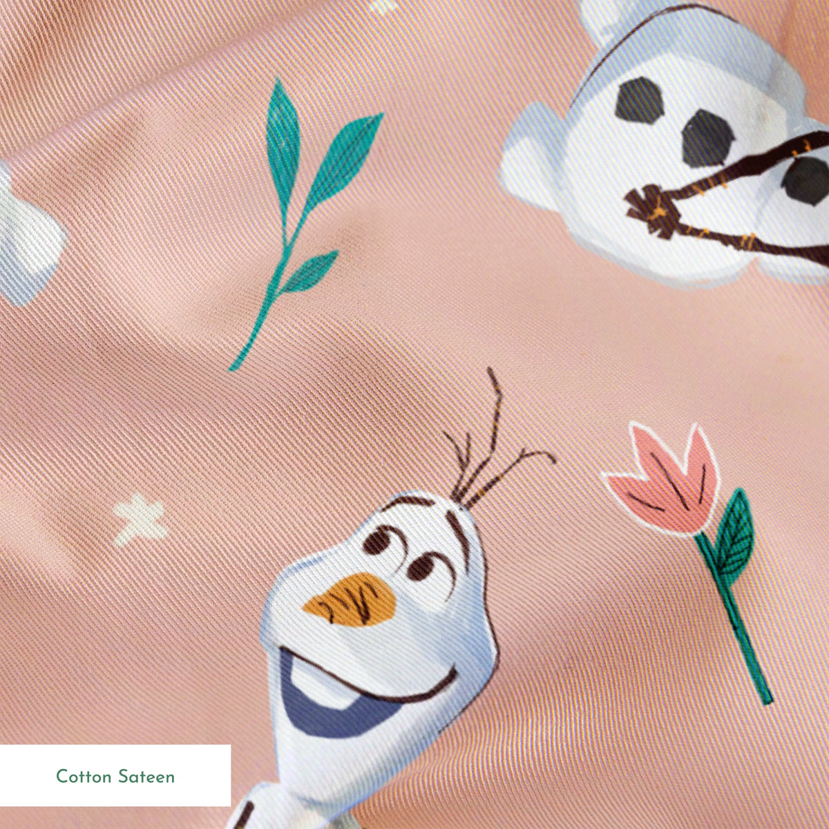 Playful pattern of Olaf scattered with green leaves on a peachy pink background springs sateen texture