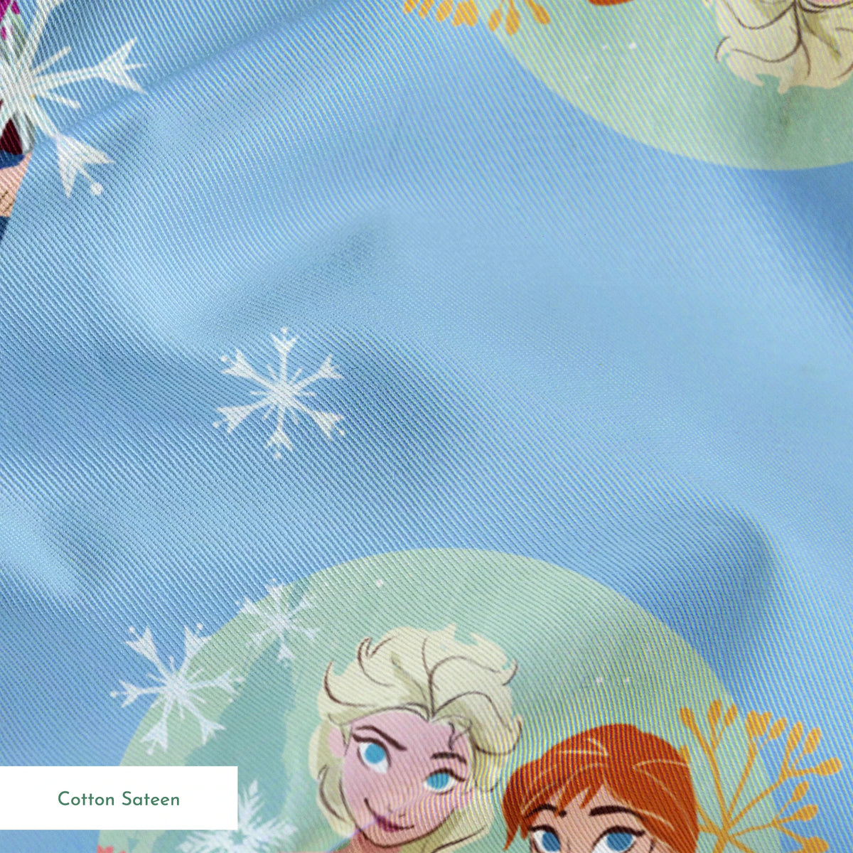 Light blue background with repeating circular motifs of "Frozen" characters and snowflakes in a decorative pattern springs sateen texture