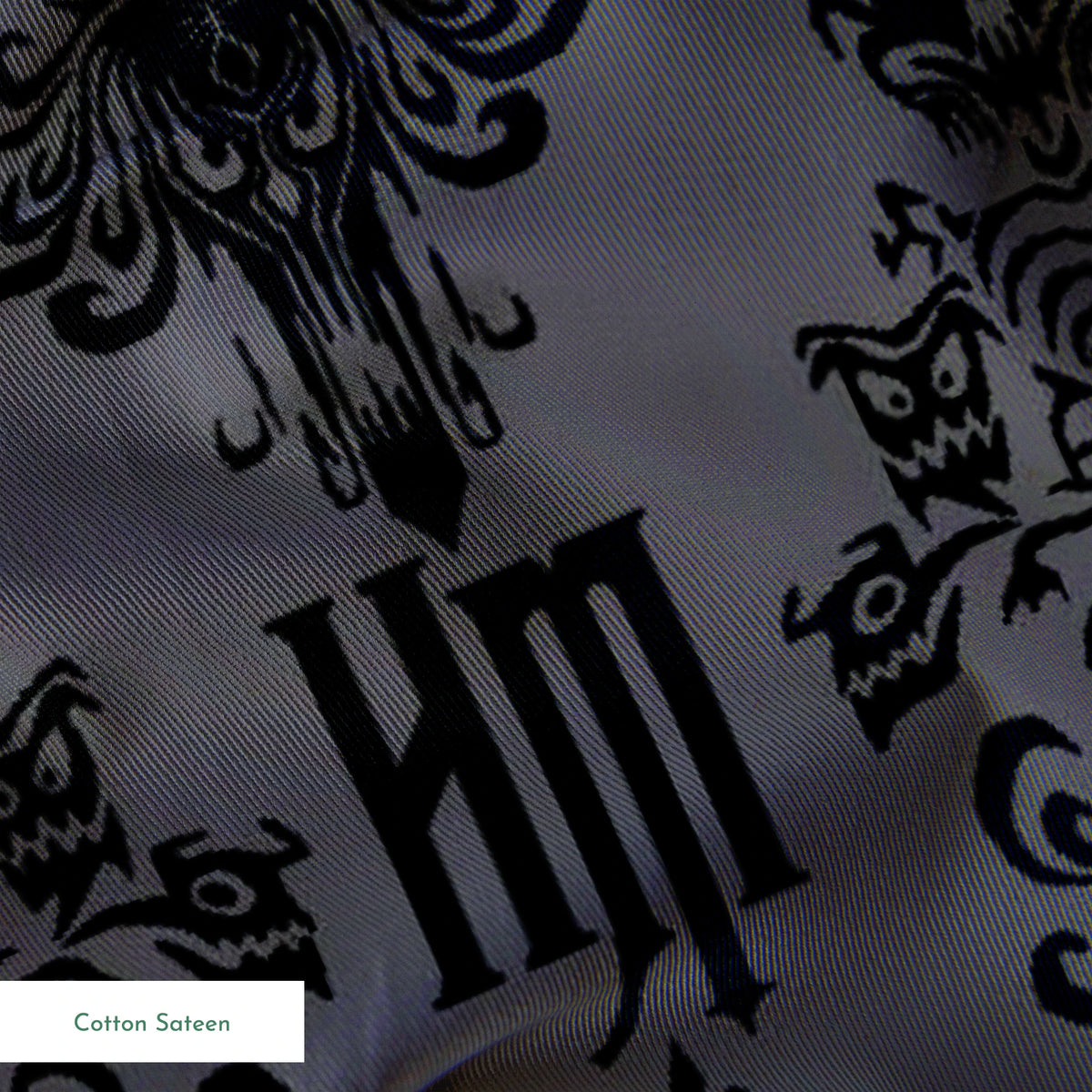 Dark gray background with black ornate damask pattern featuring decorative flourishes and monogram elements springs sateen texture