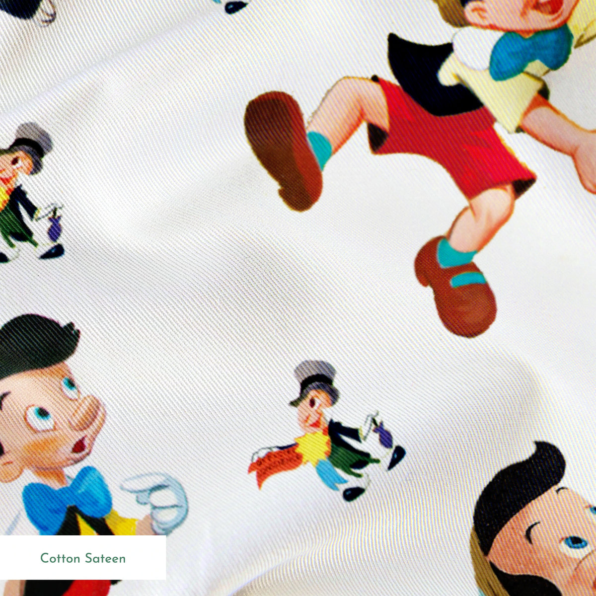 Pattern of cartoon wooden puppet characters with long noses, red shorts, blue bow ties, and black cats scattered on white background springs sateen texture