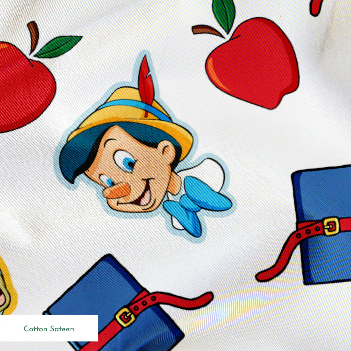 Pattern with cartoon character in pointed hat with blue bow, red apples, blue books with red straps, and yellow circular elements on white background springs sateen texture