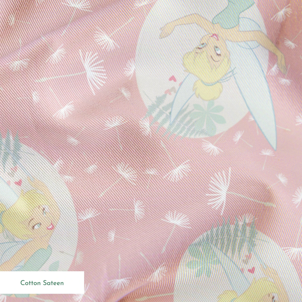 Pink background with dandelion seed pattern featuring Tinker Bell in mint green circles, whimsical Disney design springs sateen texture
