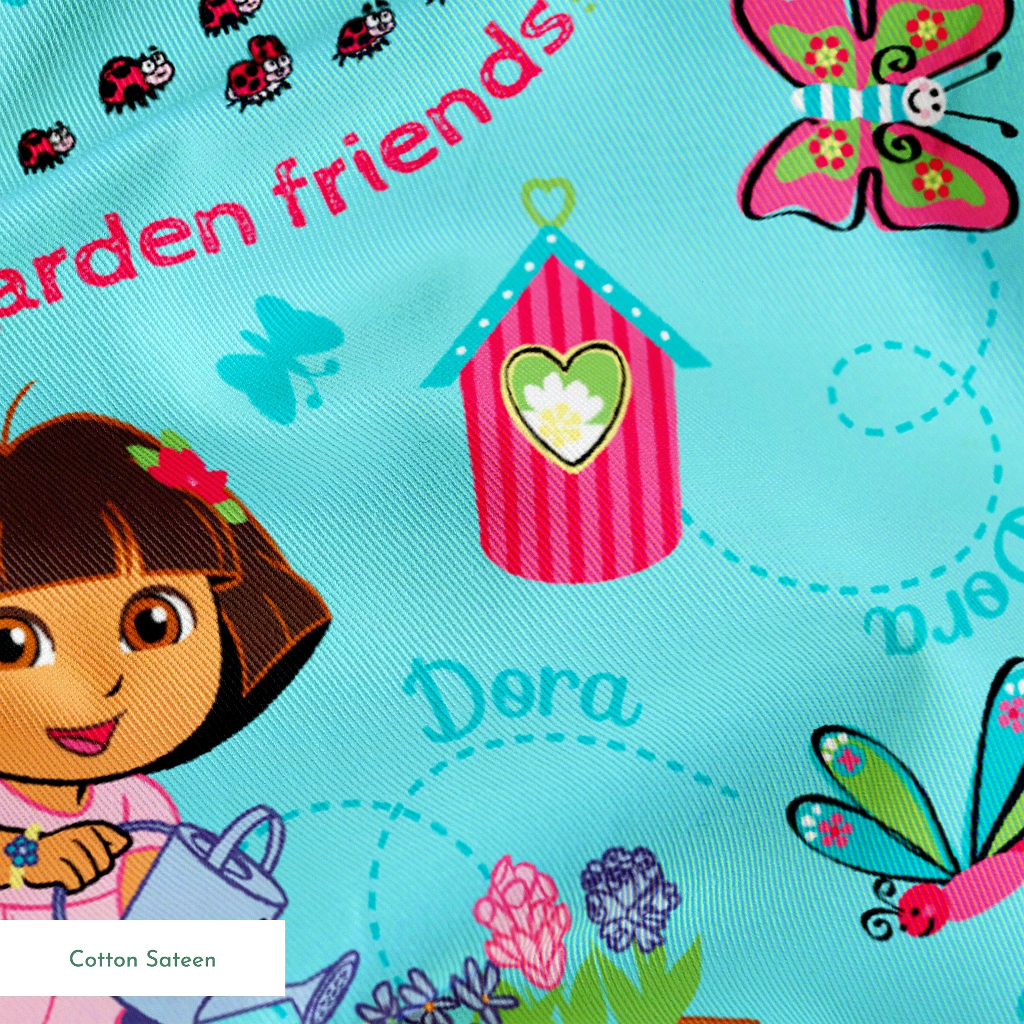 Colorful Dora the Explorer pattern on light blue background springs sateen texture