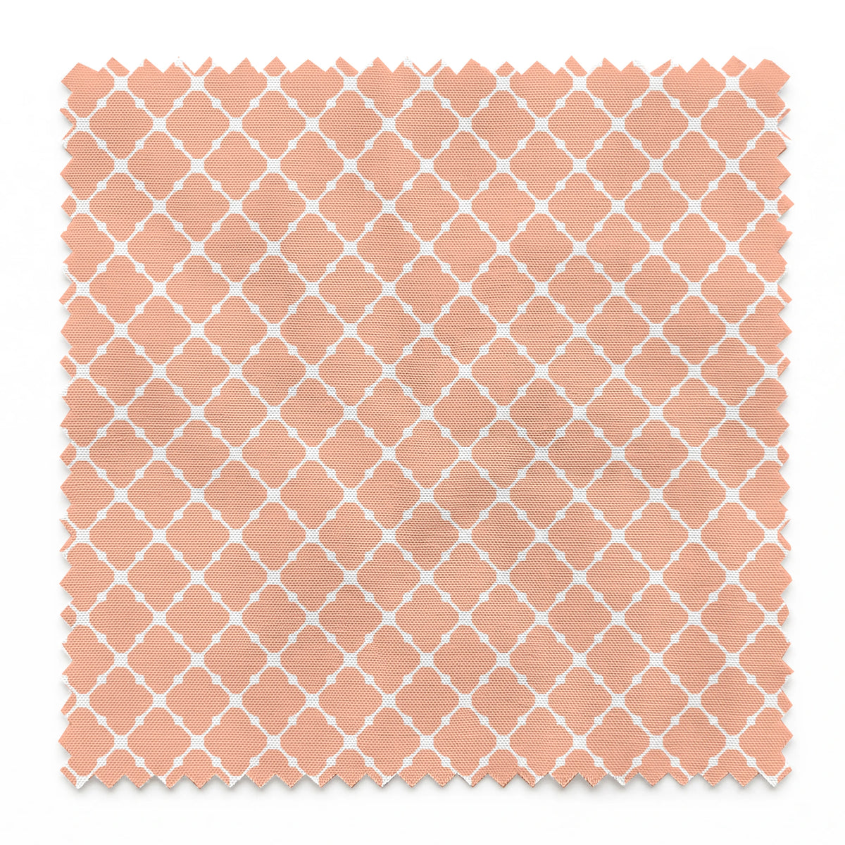 Peach and white quatrefoil pattern with regular geometric shapes in a lattice arrangement springs swatch pinked
