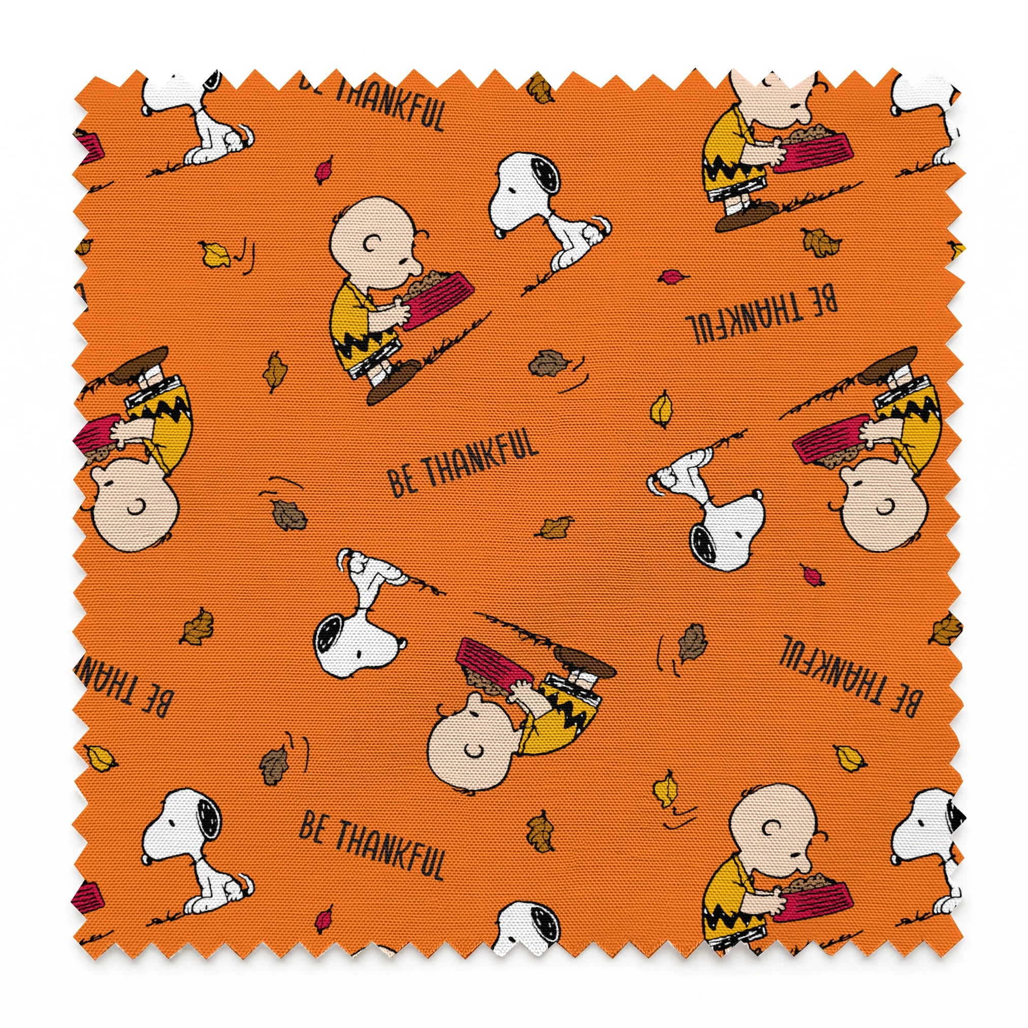 Peanuts characters on orange background with autumn leaves and "Be Thankful" text pattern springs swatch pinked