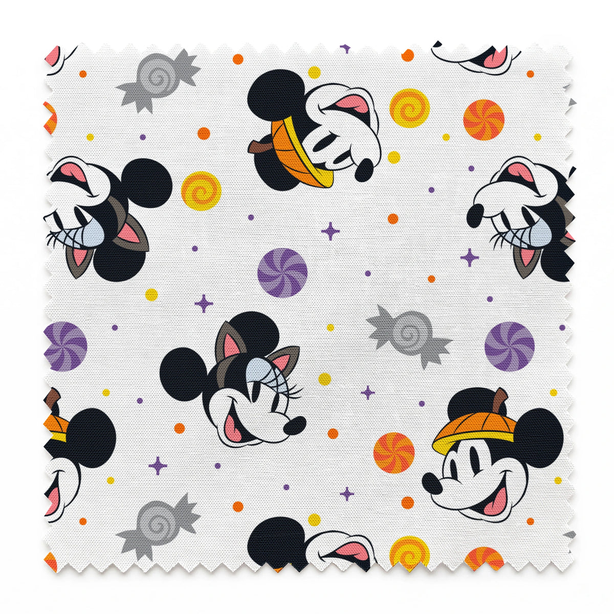 Mickey and Minnie Mouse cartoon heads scattered with wrapped candies and colorful dots on white background springs swatch pinked