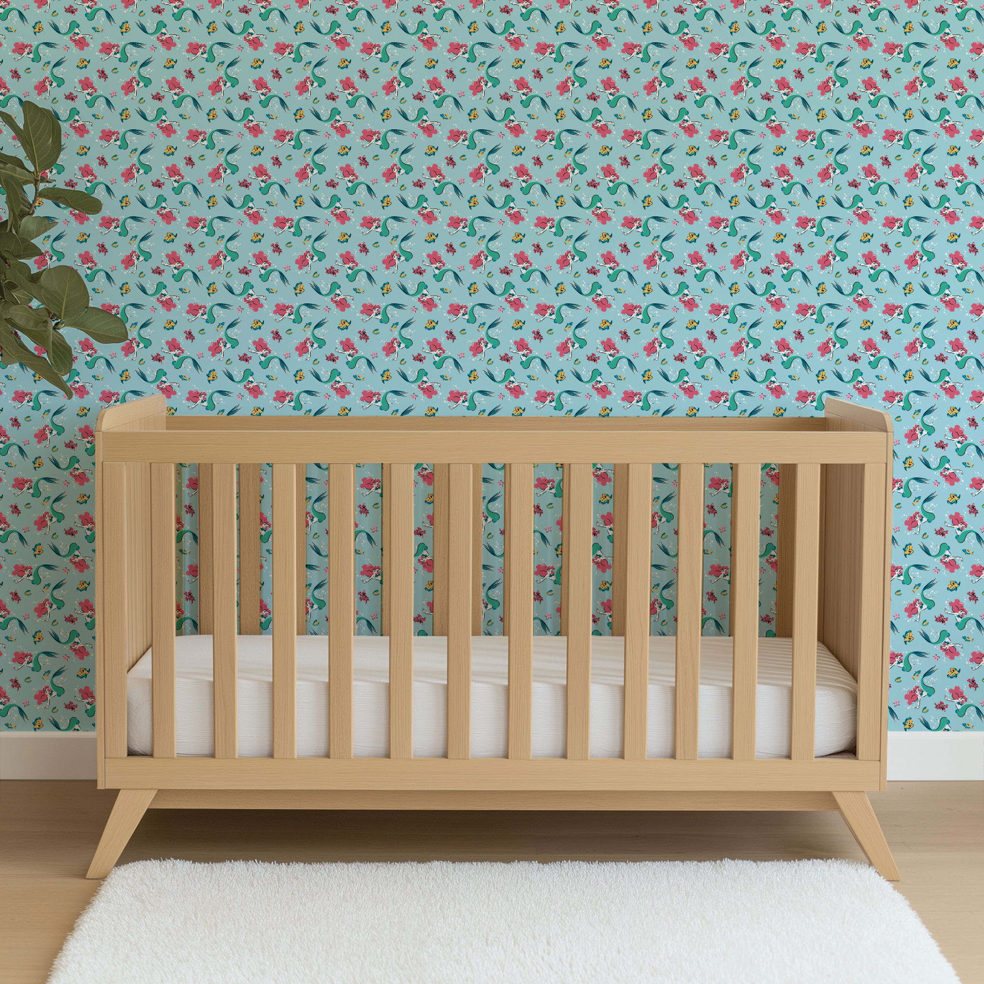 Underwater pattern with colorful mermaids, tropical fish, crabs, and starfish on light blue background wallpaper crib mockup