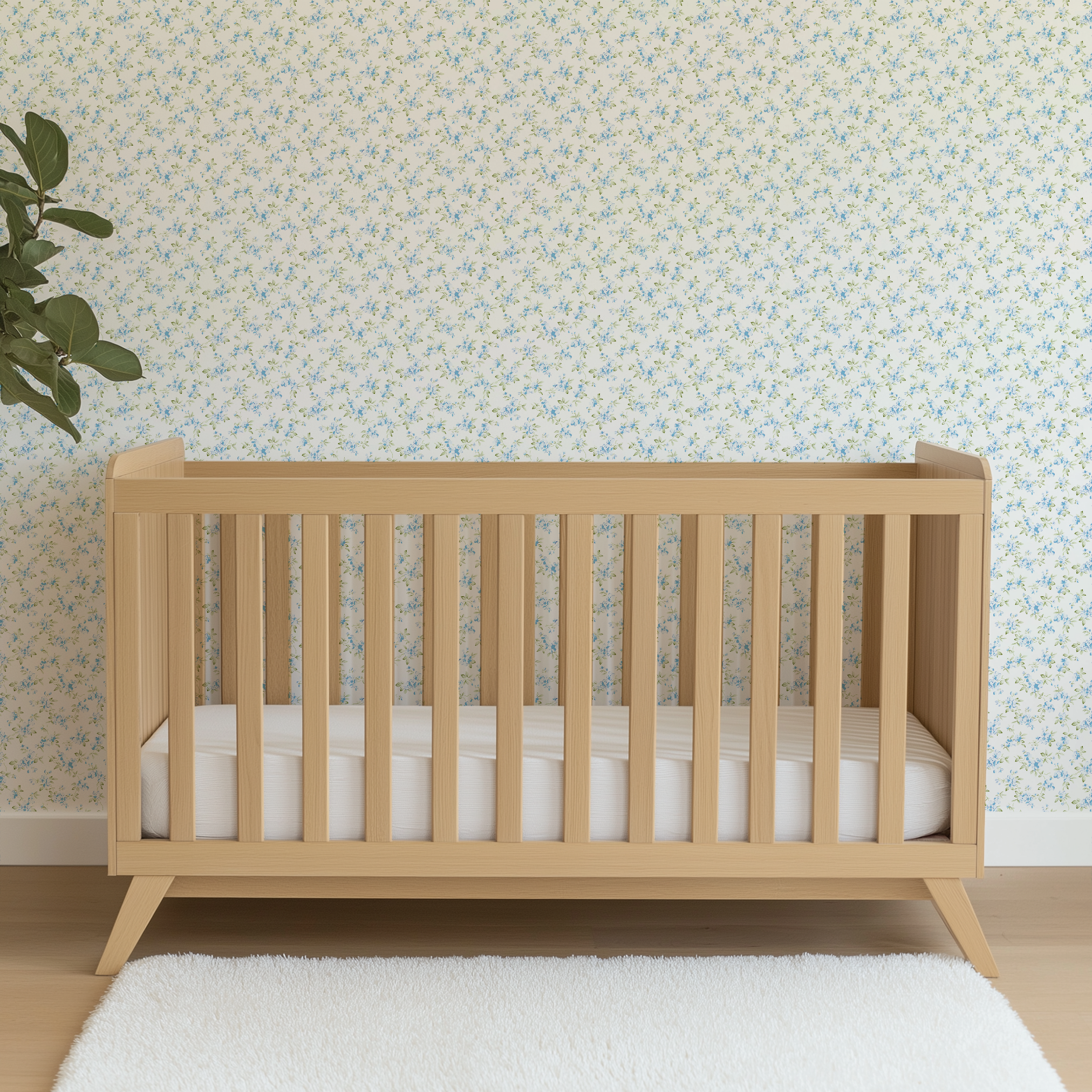 Delicate blue floral pattern with small scattered flowers and green leaves on white background wallpaper crib mockup